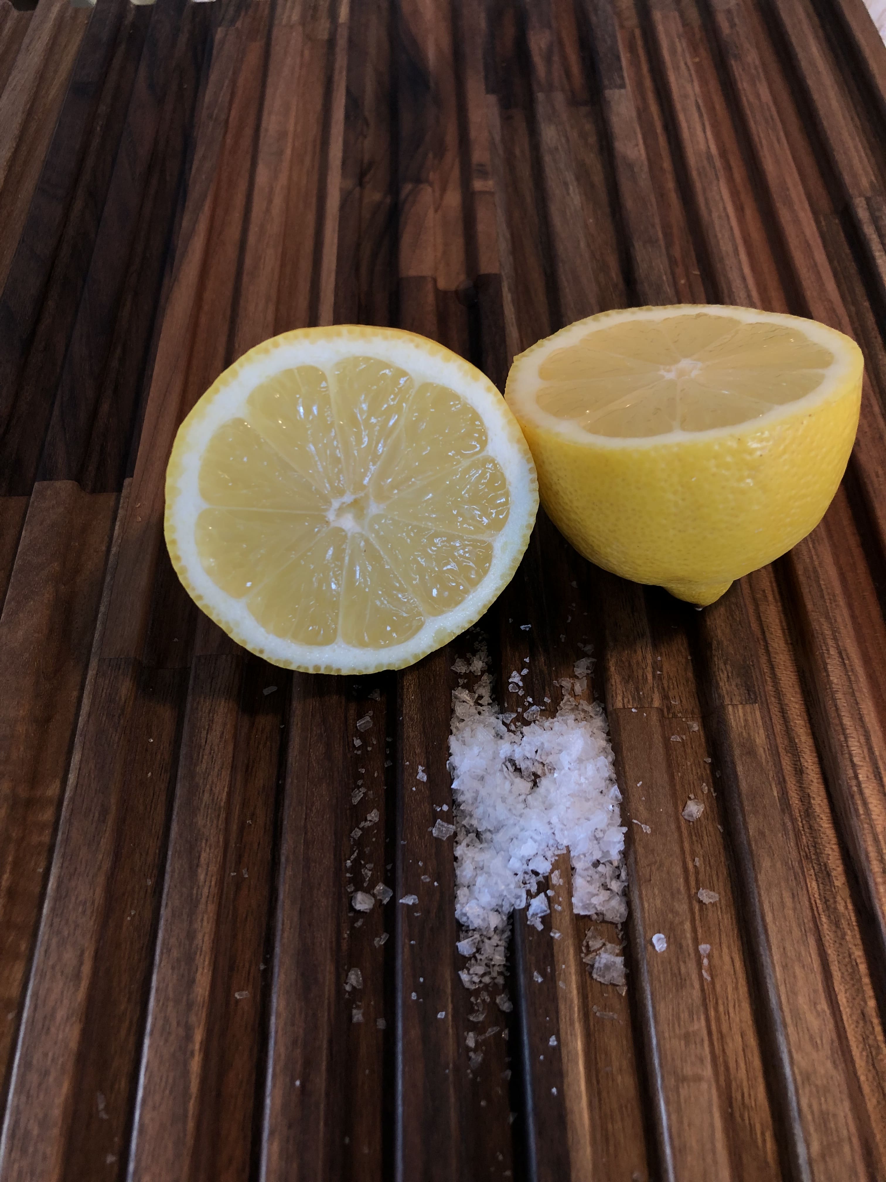 Skærebræt med grov salt og citron på